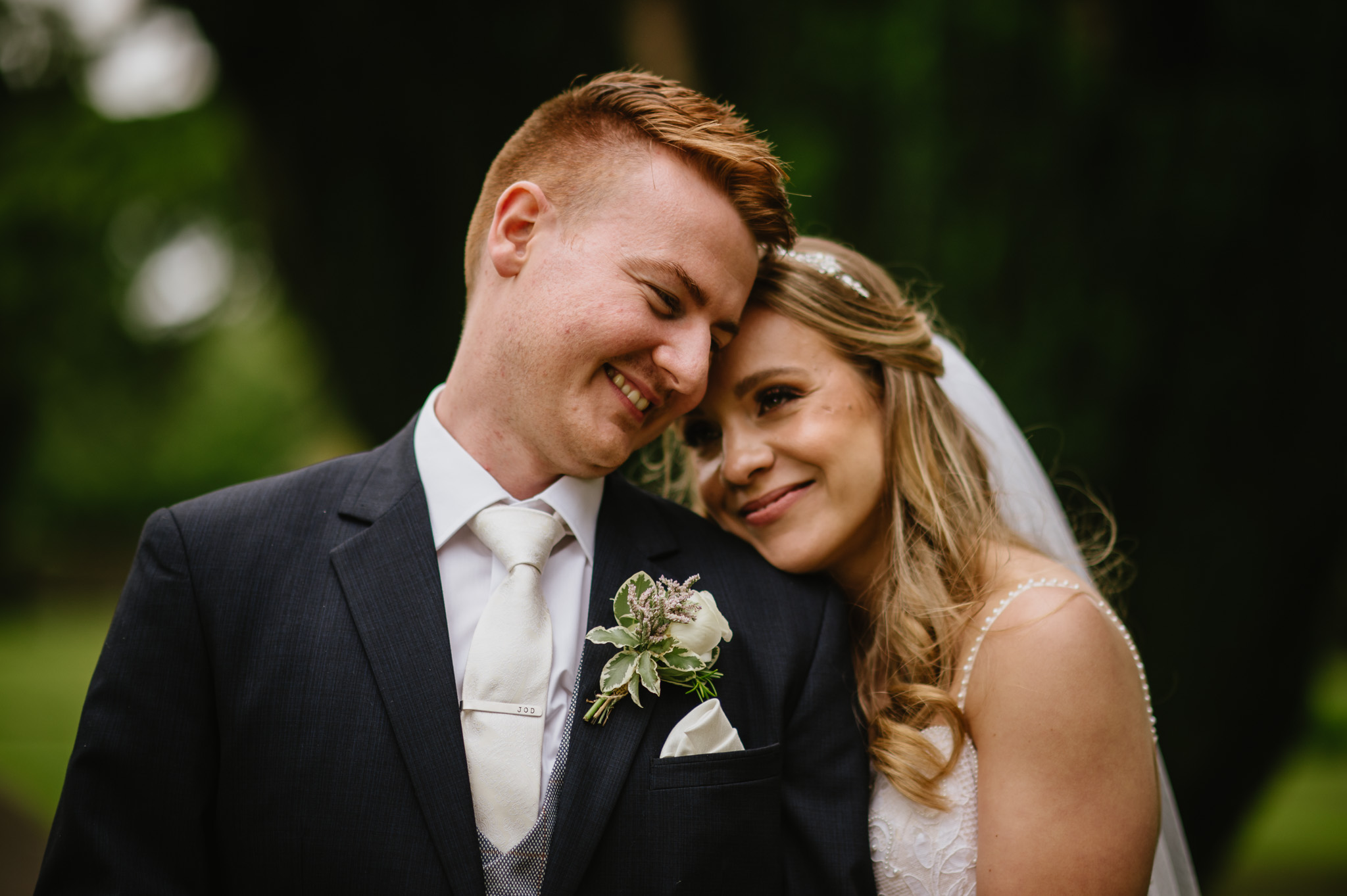 Bride and groom smiling at each other on their wedding day in Ireland.